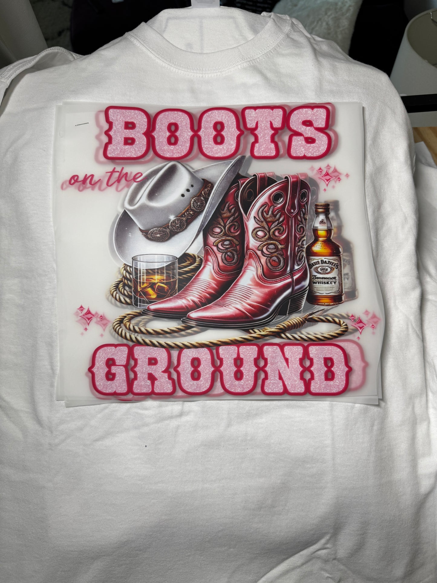 Pink boots on the ground tshirt with lasso and beverage design