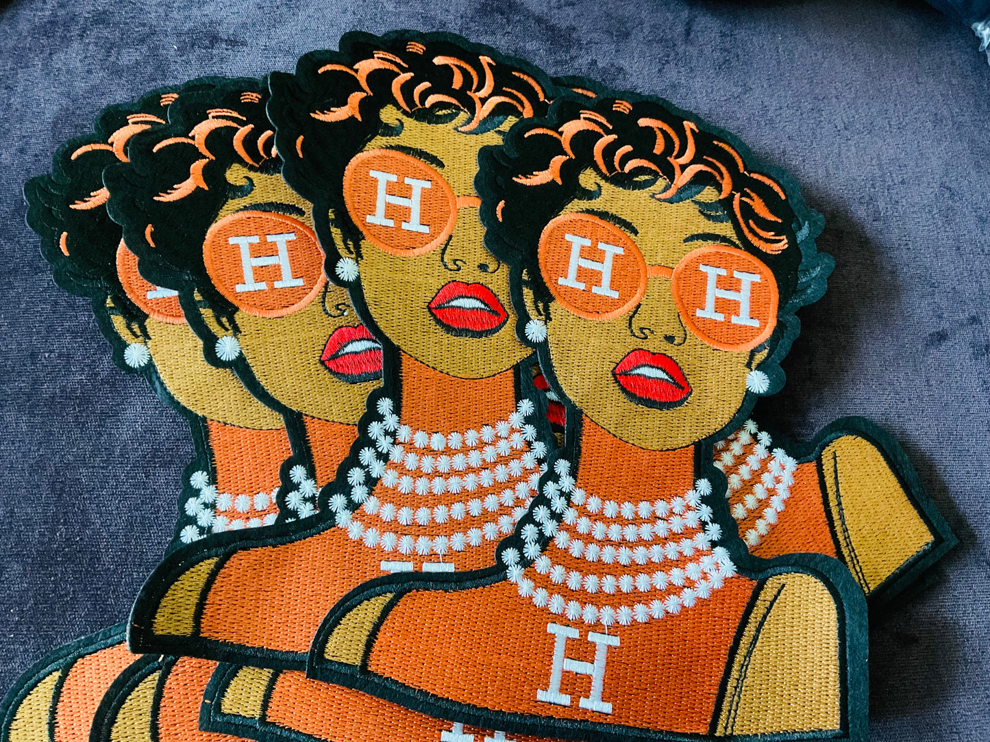 Fashion girl in Orange dress, orange glasses and pearls around the neck embroidery patch,