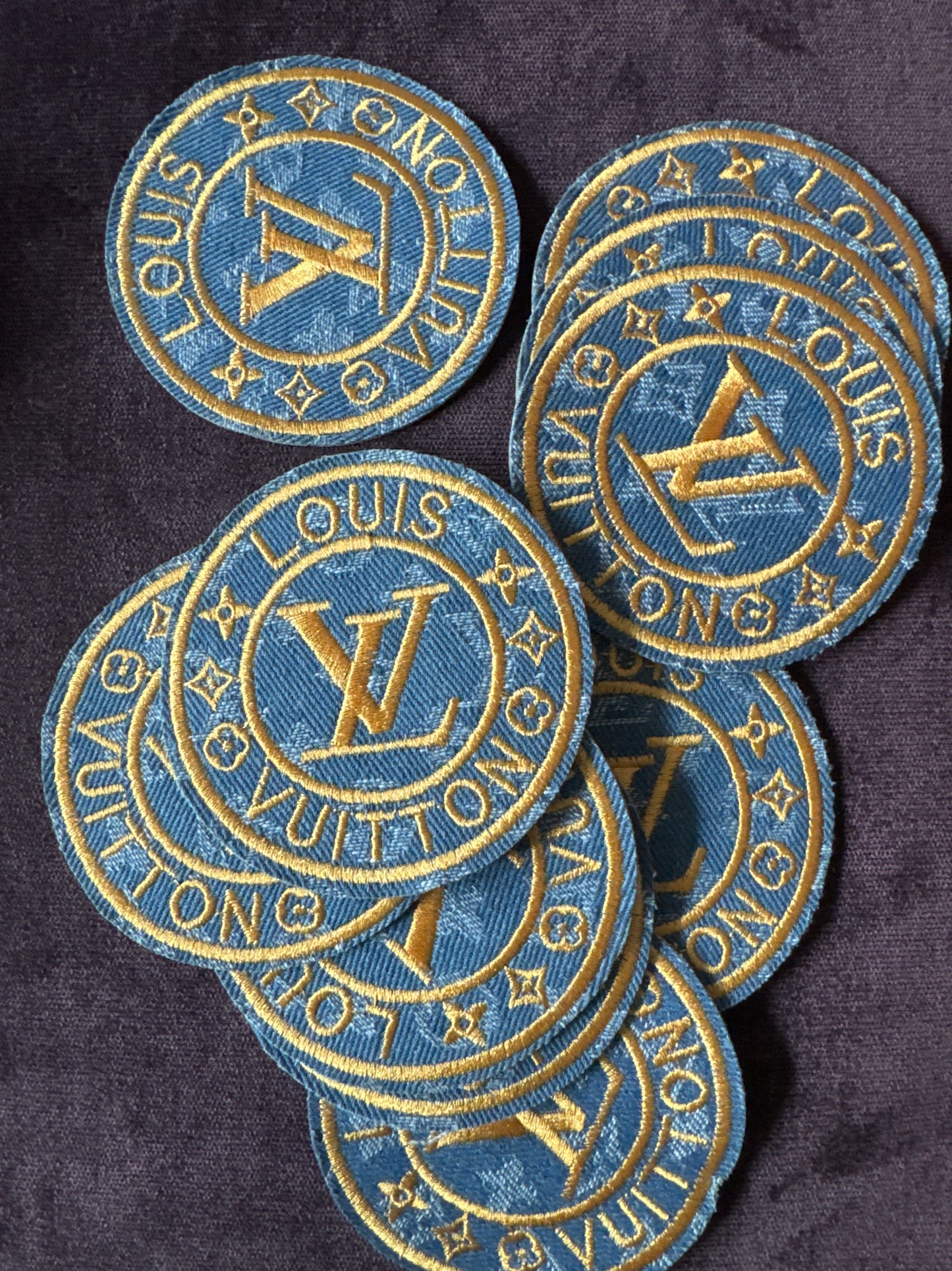 LV inspired embroidery circle patch, light denim material with writing in gold