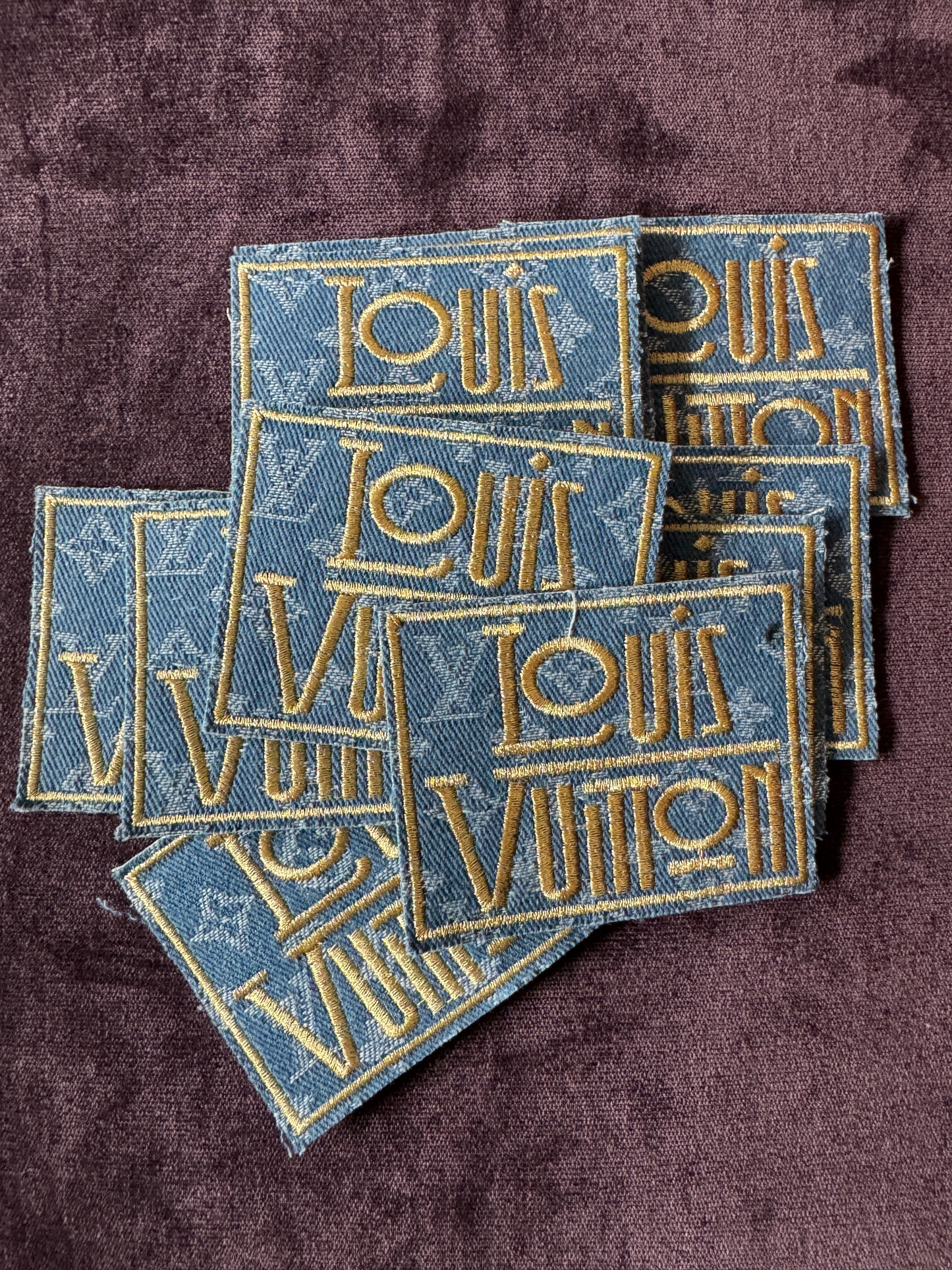 LV inspired embroidery square patch, light denim material with fancy writing in gold