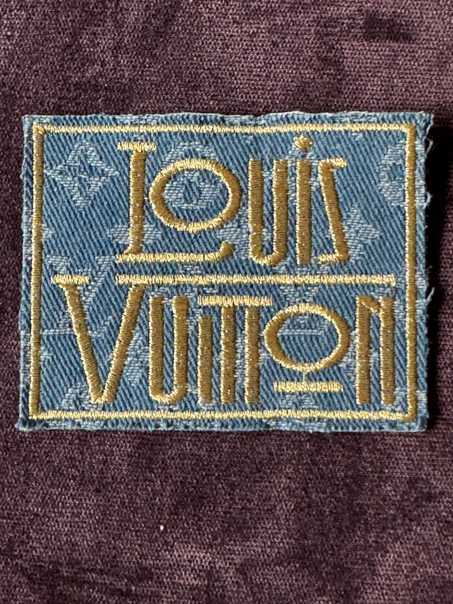LV inspired embroidery square patch, light denim material with fancy writing in gold