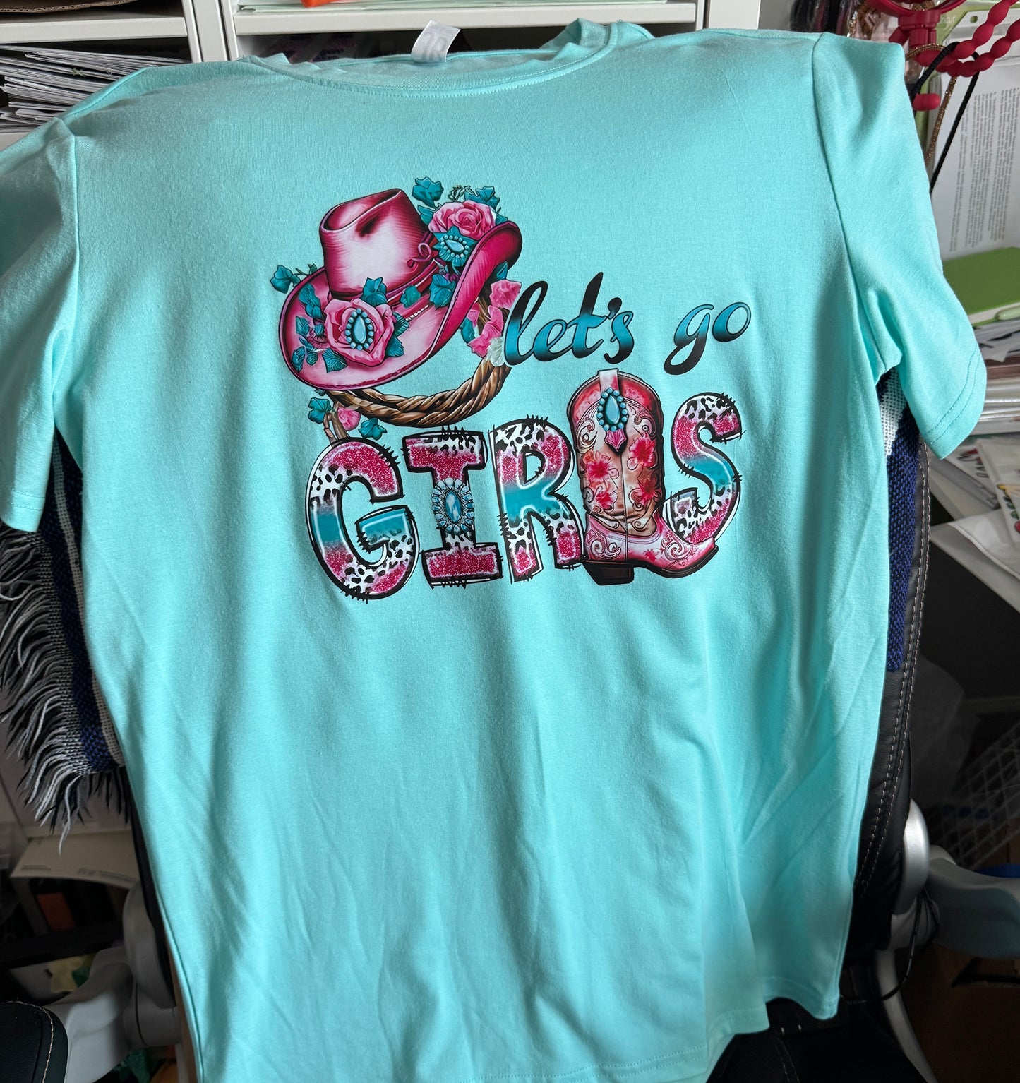 Let's go girls written in teal and pink lettering and design