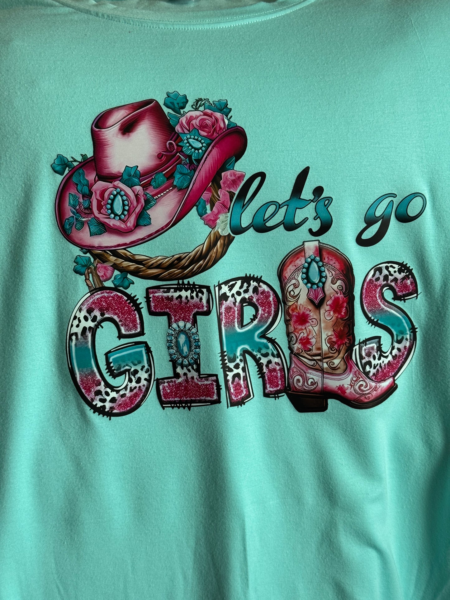 Let's go girls written in teal and pink lettering and design