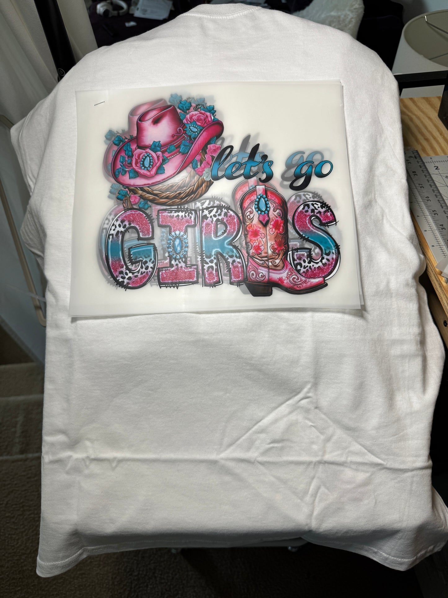 Let's go girls written in teal and pink lettering and design